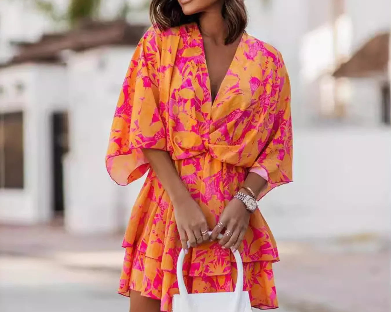 NEWYORKLISTED STYLE COLLECTION: Woman wearing a colorful dress with a blurred outdoor background