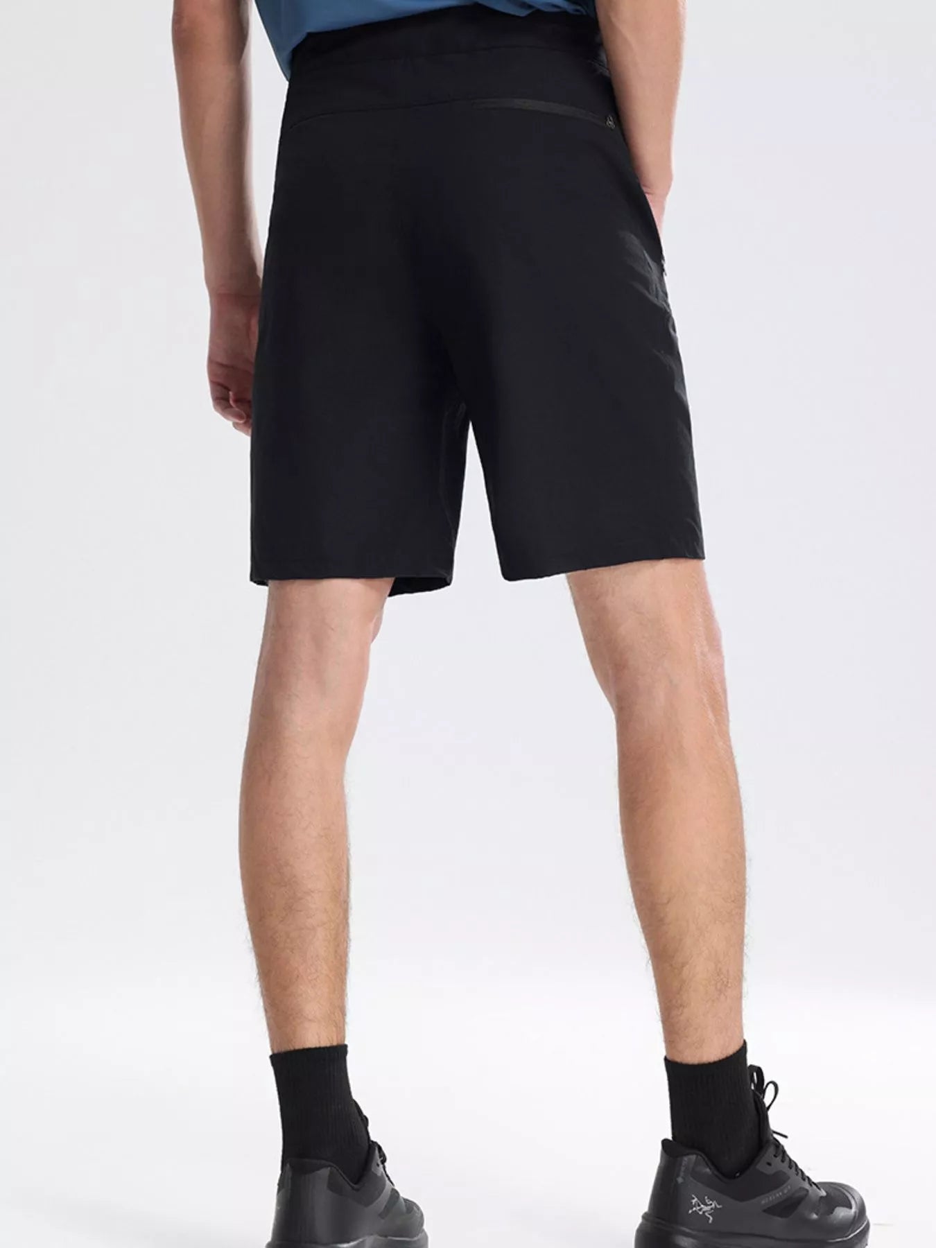 NEWYORKLISTED ATLAS MEN's COLLECTION: Person wearing black shorts on a white background