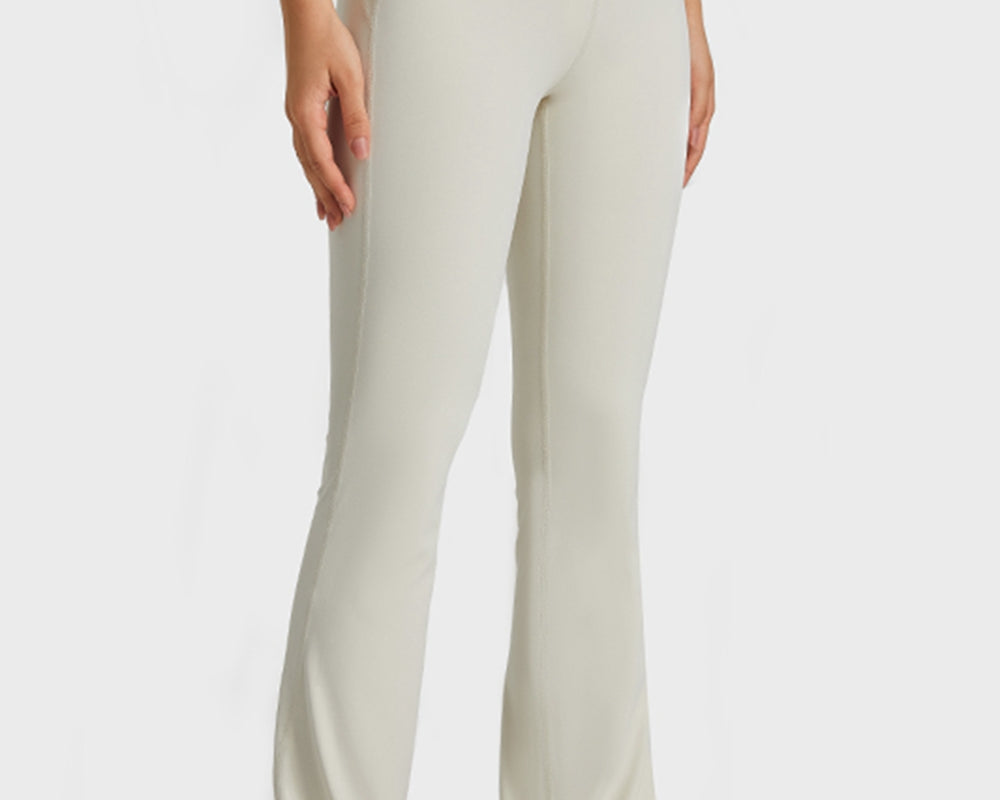 NEWYORKLISTED ACTIVEWEAR COLLECTION: Person wearing beige high-waisted pants on a white background