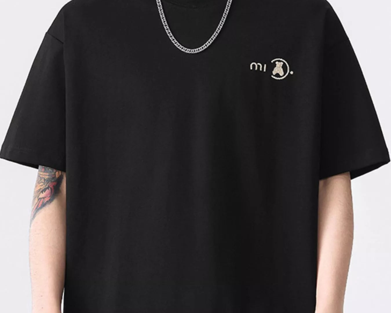 NEWYORKLISTED ATLAS MEN'S COLLECTION: Person wearing a black t-shirt with a logo on a white background