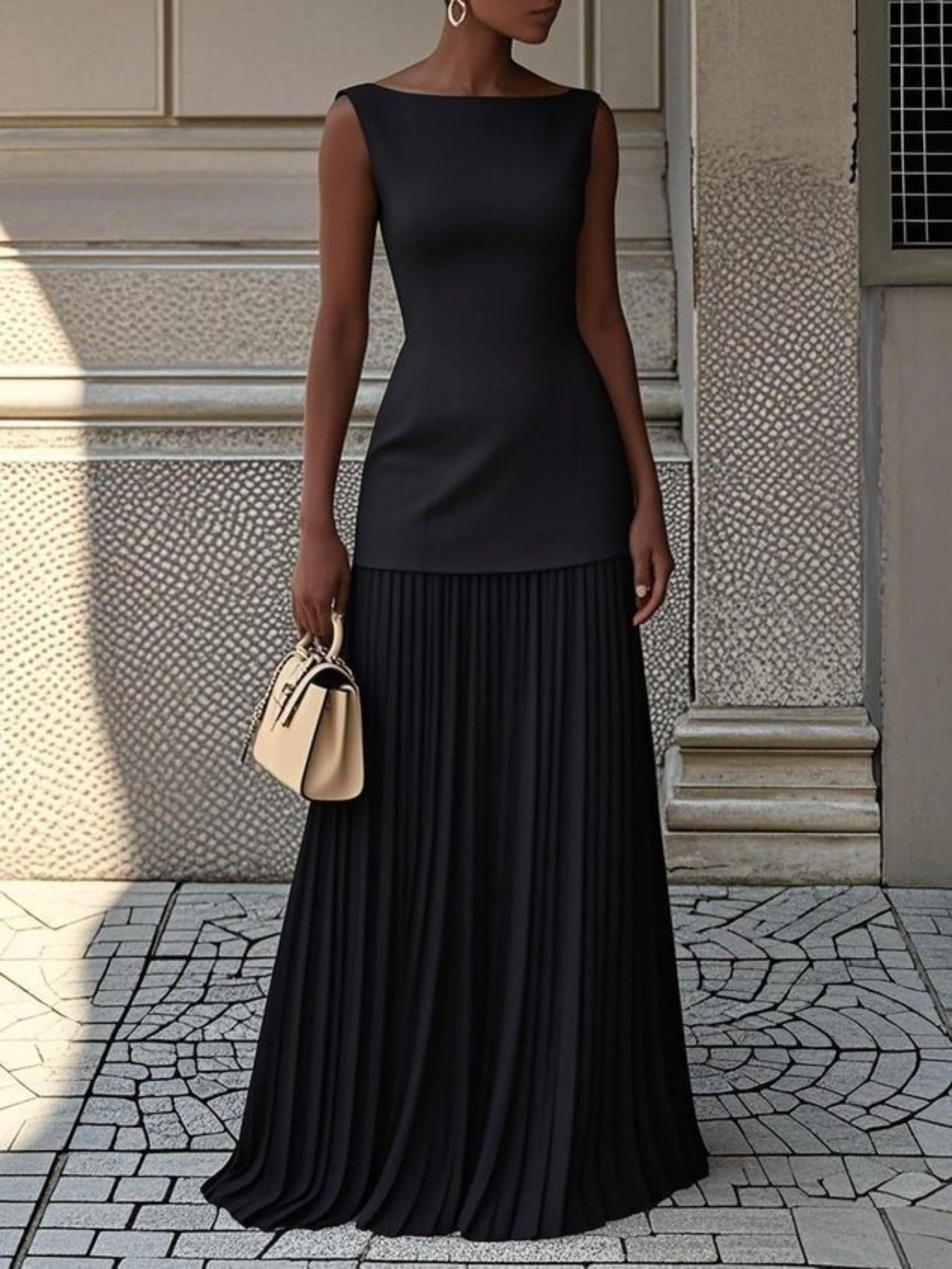 NEWYORKLISTED STYLE COLLECTION: Woman wearing a black dress standing on a stone pavement with a light-colored wall in the background.