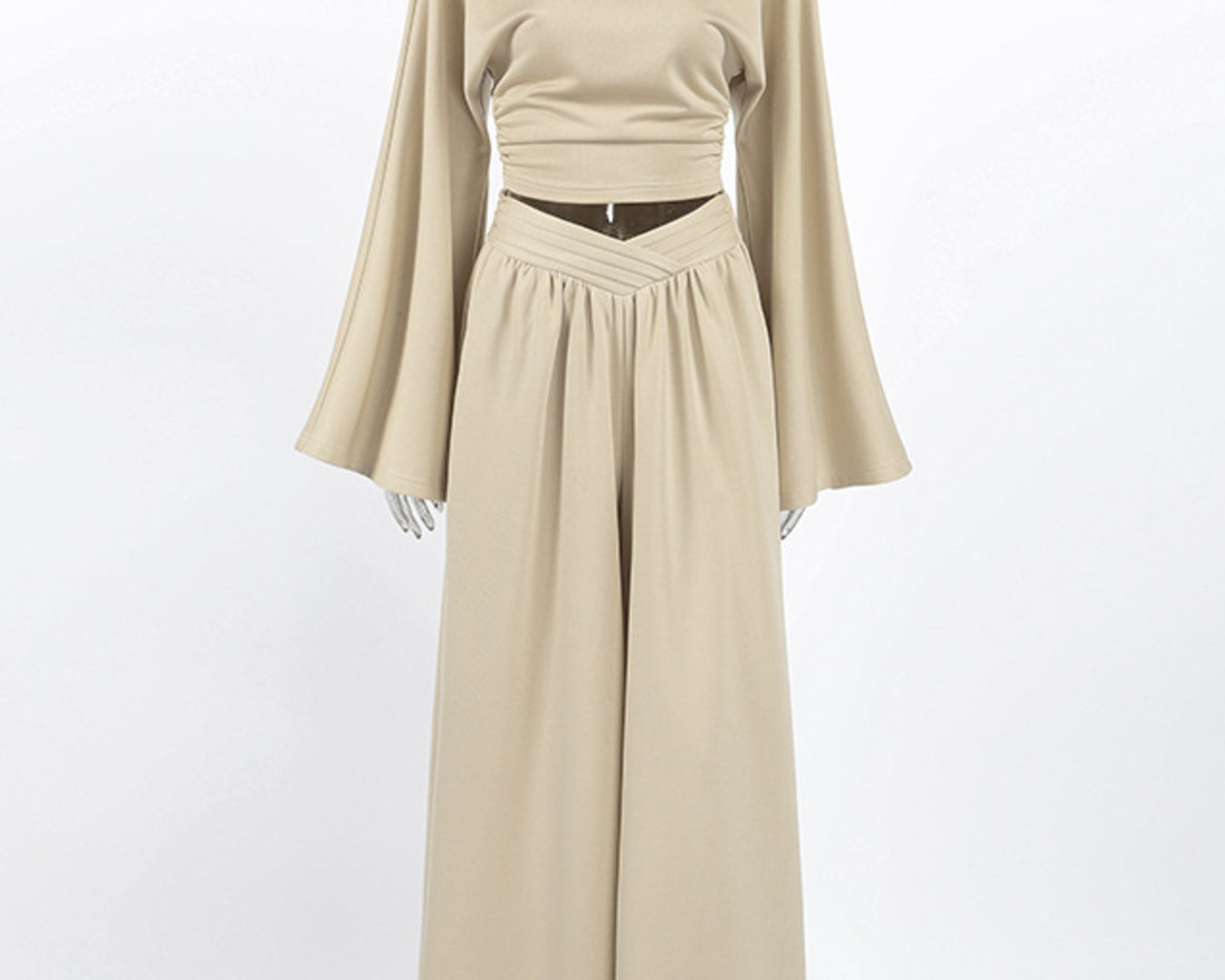 NEWYORKLISTED STYLE COLLECTION: Beige long-sleeve top and skirt set on a mannequin against a white background