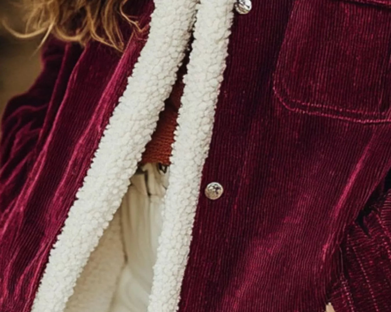 NEWYORKLISTED STYLE COLLECTION: Close-up of a burgundy corduroy jacket with white fleece lining.