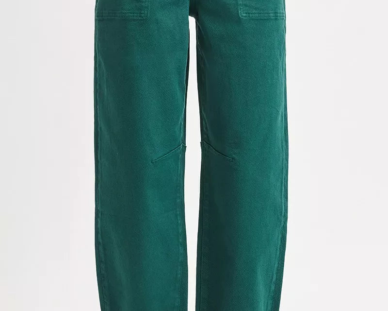 Green pants worn by a person on a white background: NEWYORKLISTED STYLE COLLECTION