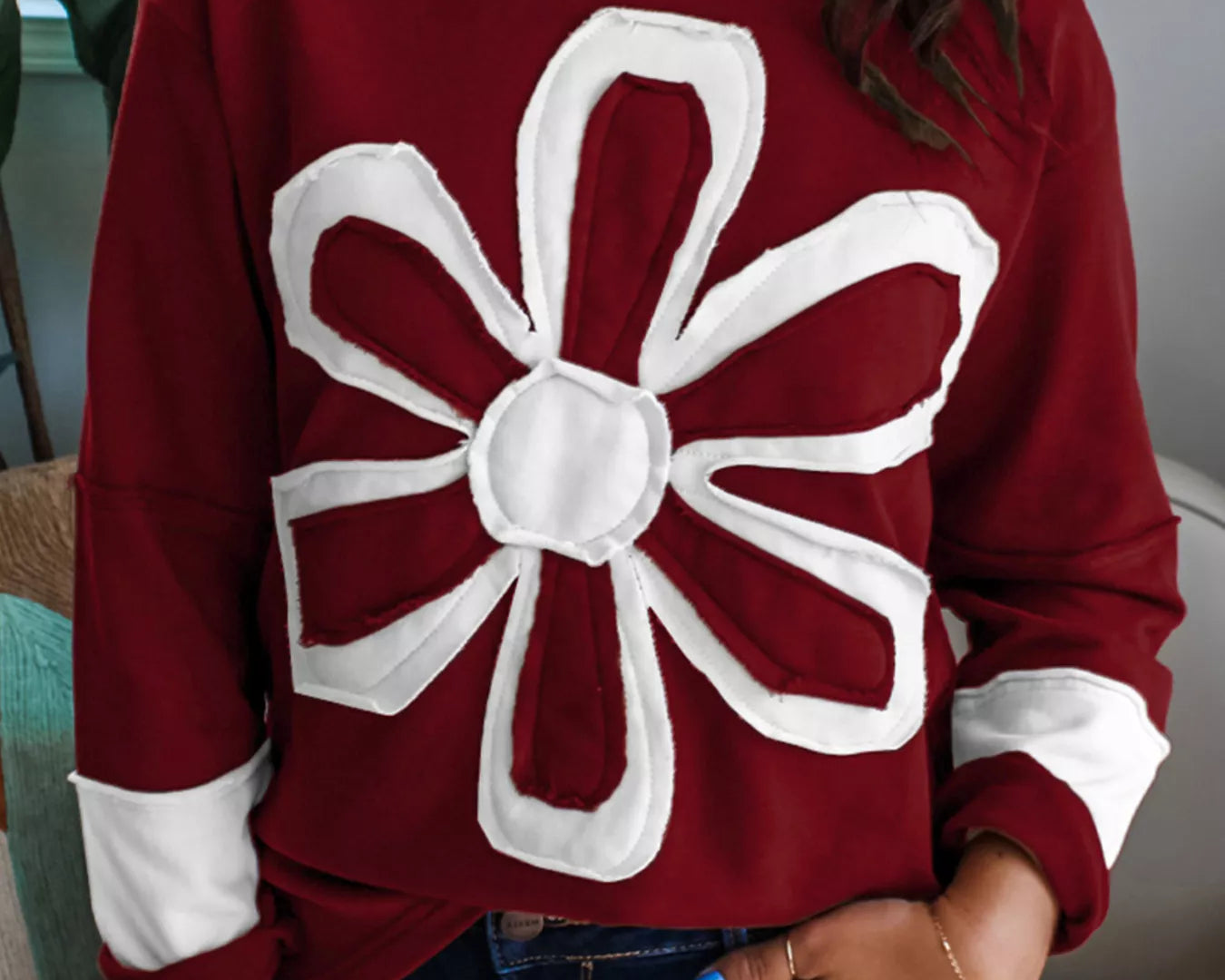 NEWYORKLISTED STYLE COLLECTION – Flower Patched Round Neck Long Sleeve Top | Casual Chic Everyday Style | Soft Stretch Knit: Person wearing a maroon sweater with a large white flower design.