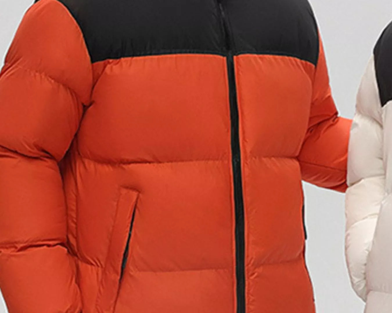NEWYORKLISTED ATLAS MEN’S COLLECTION: Orange red and black puffer jacket worn by a person on a plain background