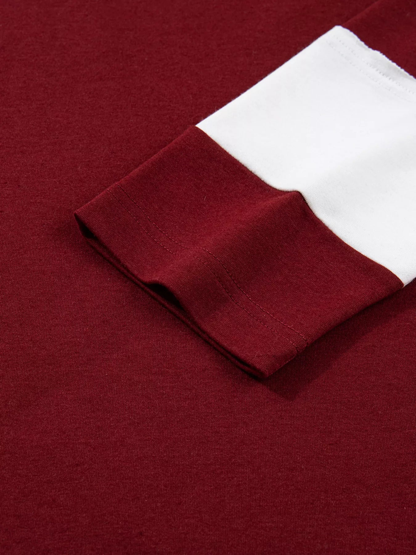 Close-up of a burgundy fabric with a white trim pocket