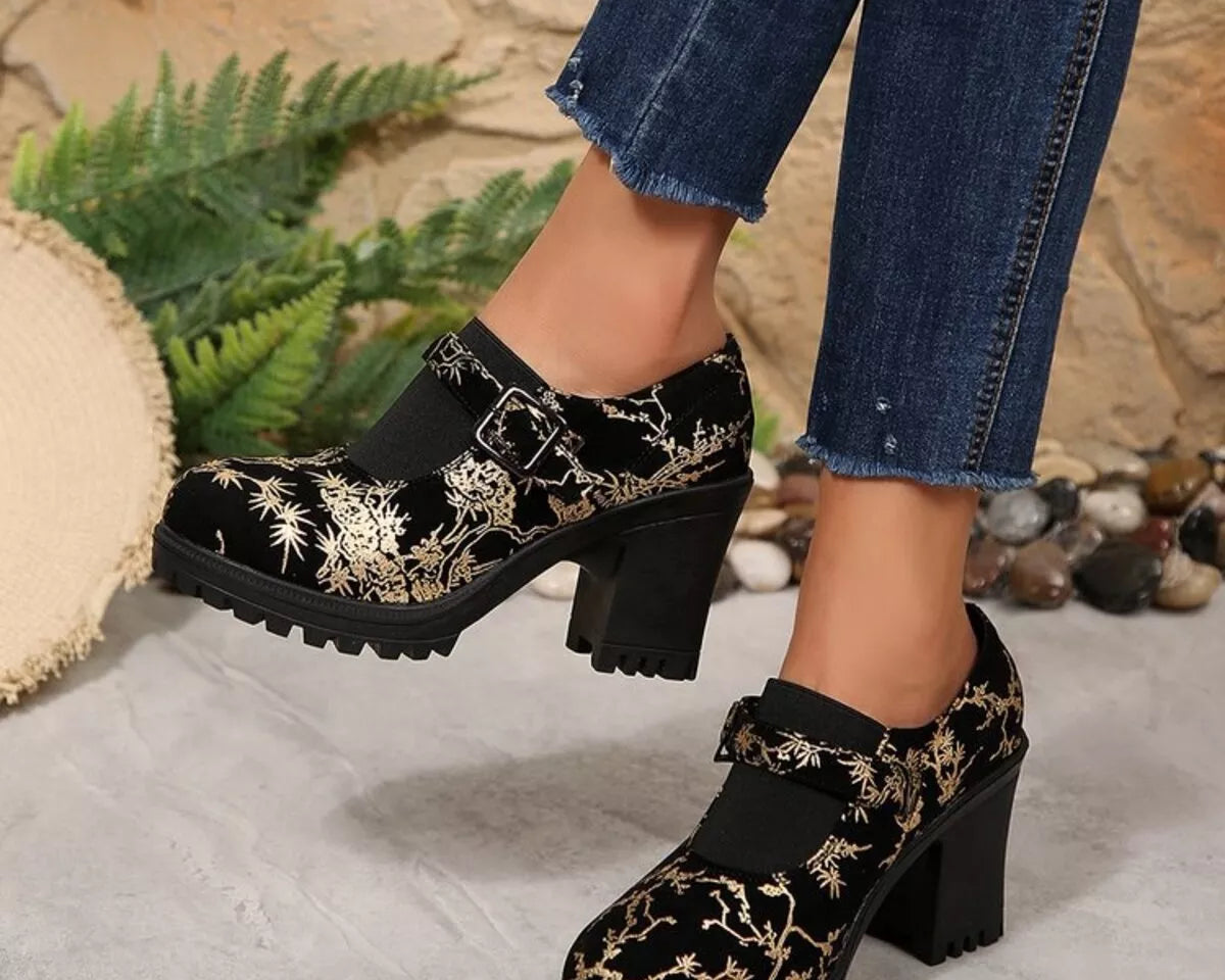 NEWYORKLISTED STYLE COLLECTION: Black floral embroidered shoes worn with blue jeans against a natural stone and plant background