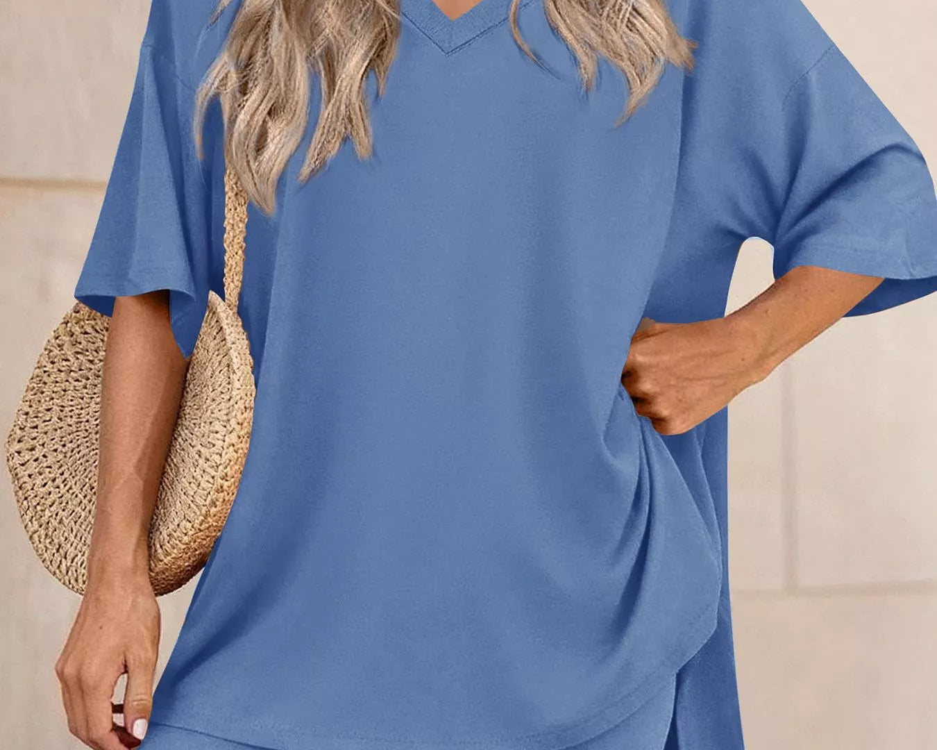 Woman wearing a blue outfit with a plain background