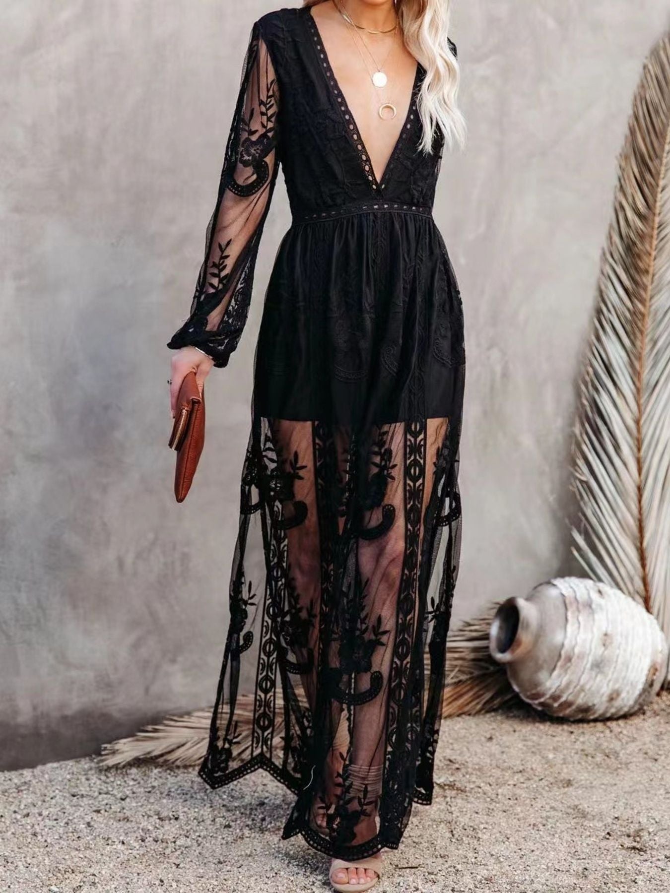 NEWYORKLISTED STYLE COLLECTION: Black lace dress worn by a person against a neutral background