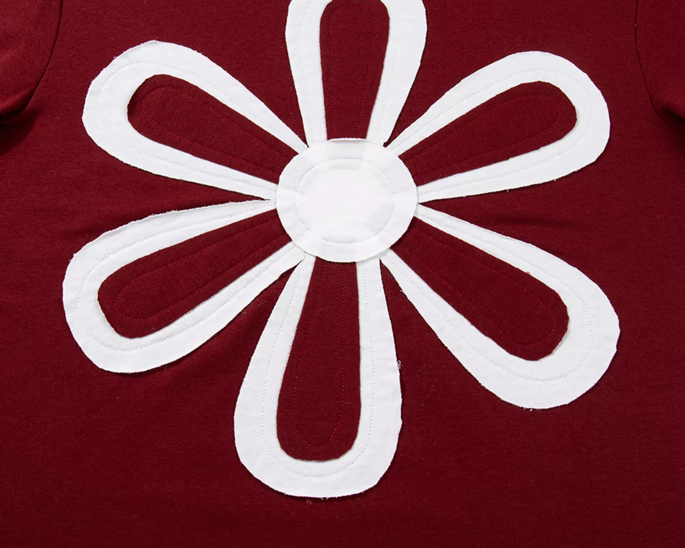 NEWYORKLISTED STYLE COLLECTION: Red shirt with a white flower design on a beige background