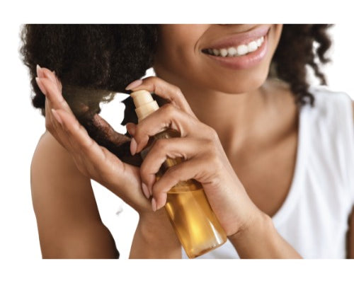 Woman applying NEWYORKLISTED castor oil hair product to her hair with a white background