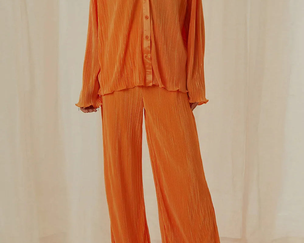 NEWYORKLISTED Intimate Apparel Collection: Orange outfit with a shirt and pants on a neutral background