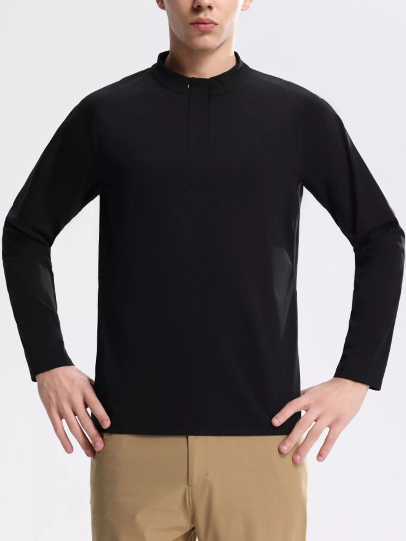 NEWYORKLISTED ATLAS MEN's COLLECTION: Person wearing a black long-sleeve shirt and beige pants on a light gray background