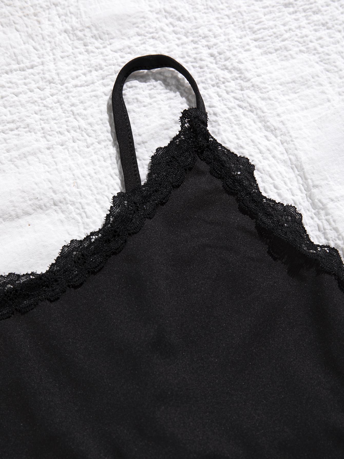 Black lace-trimmed garment on a textured white background