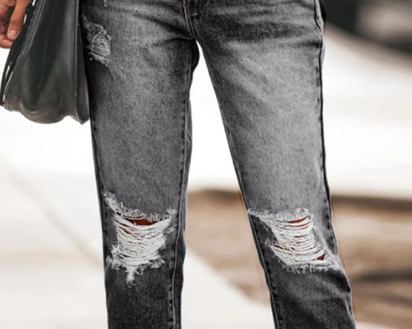 NEWYORKLISTED STYLE COLLECTION: Person wearing distressed black jeans with a blurred background
