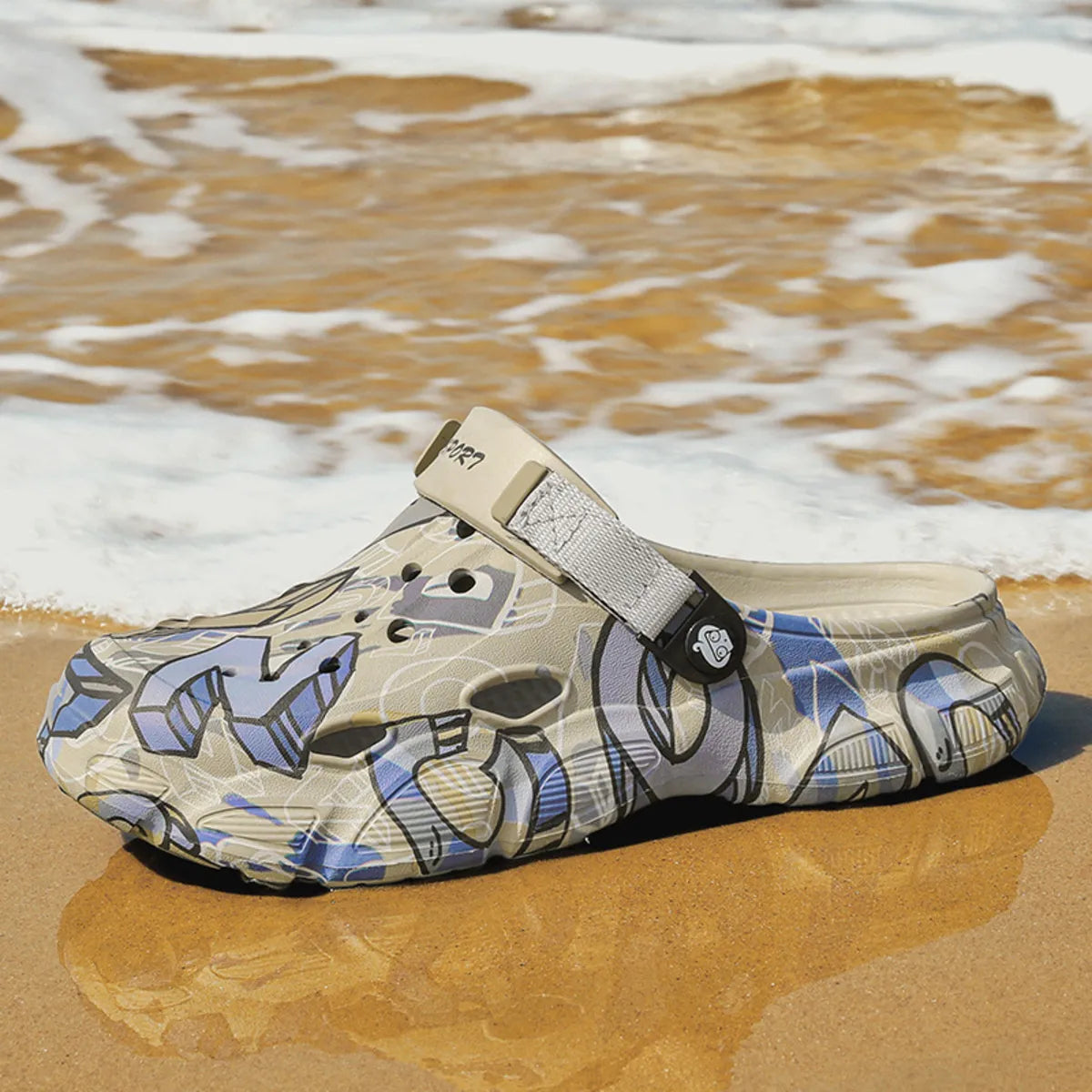 NEWYORKLISTED ATLAS MEN'S COLLECTION: Croc-style shoe with graphic design on a sandy beach