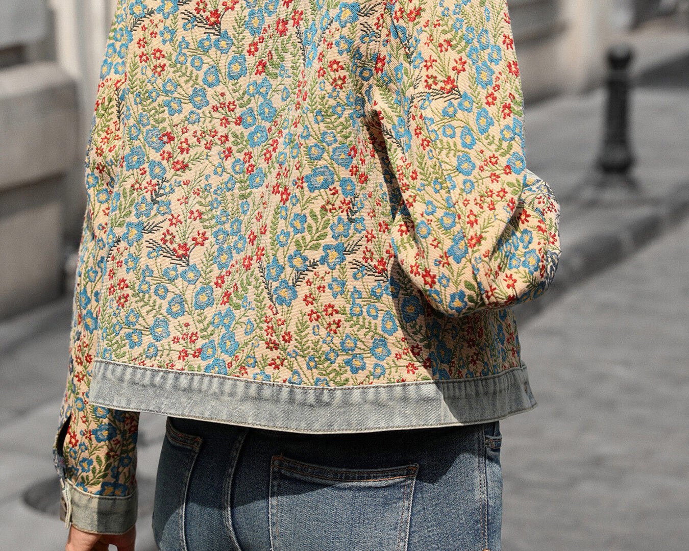 NEWYORKLISTED STYLE COLLECTION: Person wearing a floral patterned jacket on a city street.