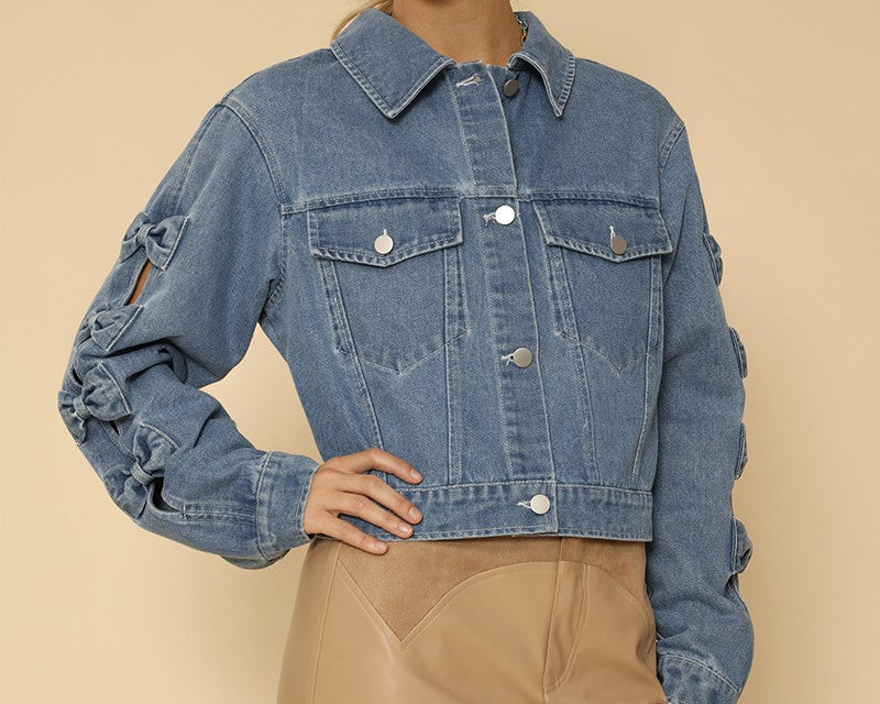 NEWYORKLISTED STYLE COLLECTION: Woman wearing a blue denim jacket and beige skirt on a beige background