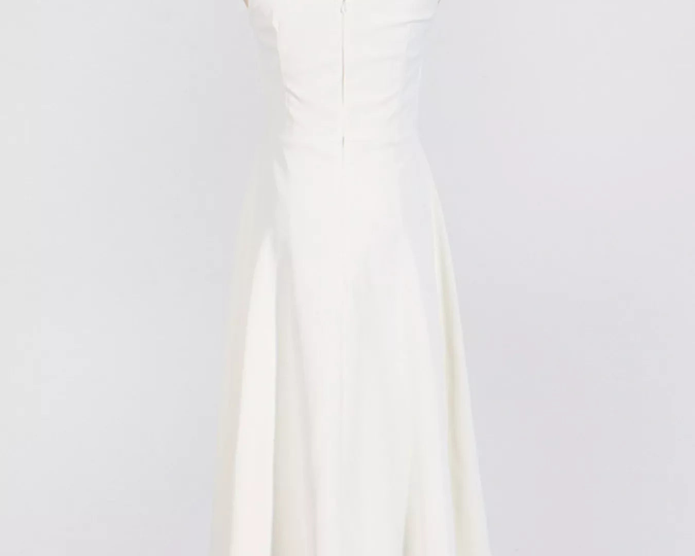 NEWYORKLISTED STYLE COLLECTION: White sleeveless dress on a mannequin against a white background