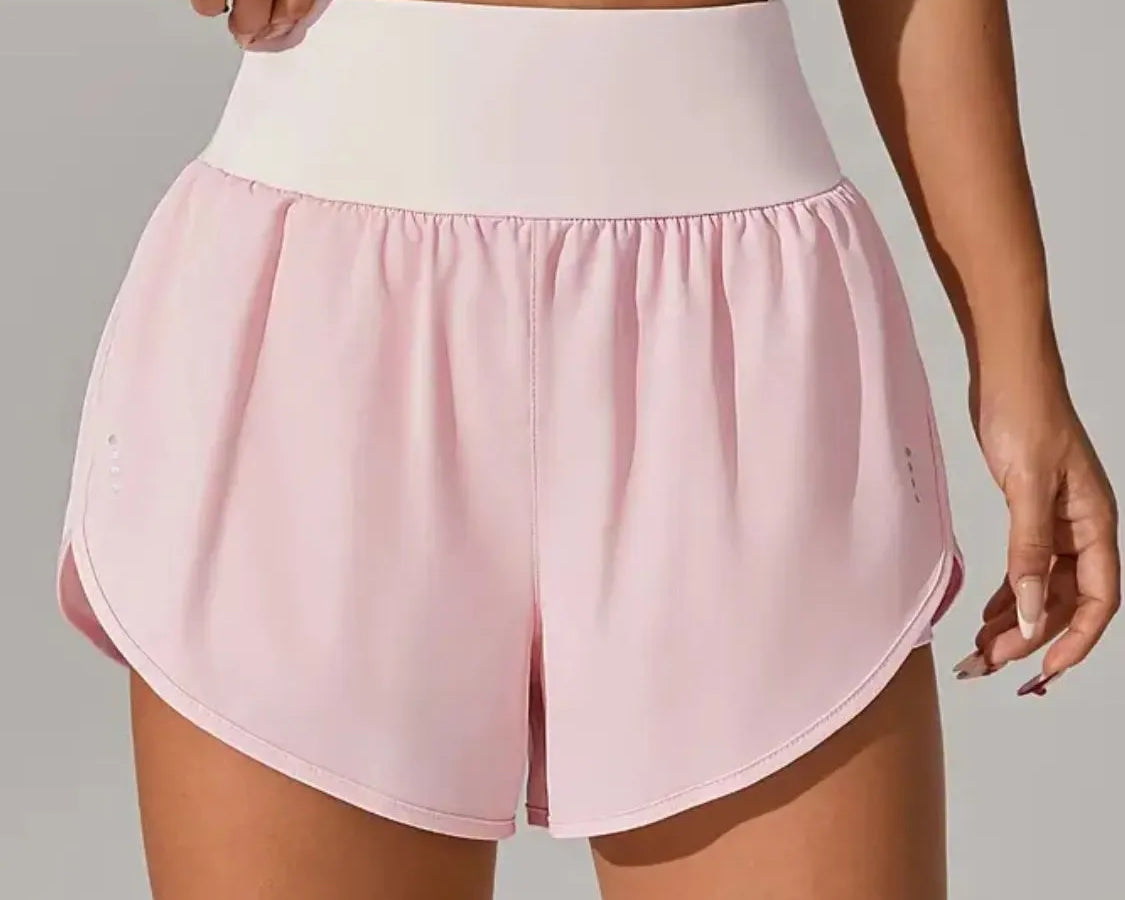 NEWYORKLISTED Activewear: Person wearing pink athletic shorts and a white top on a plain background