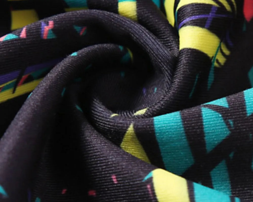 NEWYORKLISTED ACTIVEWEAR COLLECTION: Close-up of colorful fabric with abstract patterns on a black background