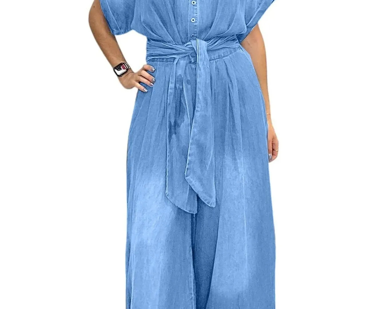 NEWYORKLISTED STYLE COLLECTION: Woman wearing a blue denim jumpsuit on a white background