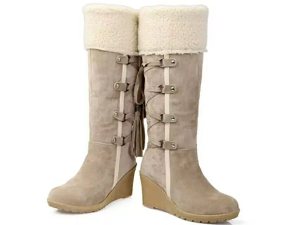 NEWYORKLISTED SHOE COLLECTION: Pair of beige knee-high boots with white fur lining on a white background