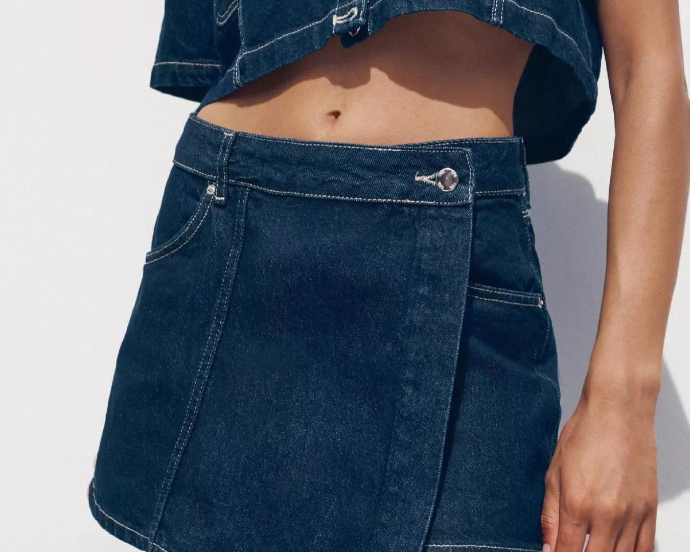 NEWYORKLISTED STYLE COLLECTION: Person wearing a blue denim skirt and jacket on a white background