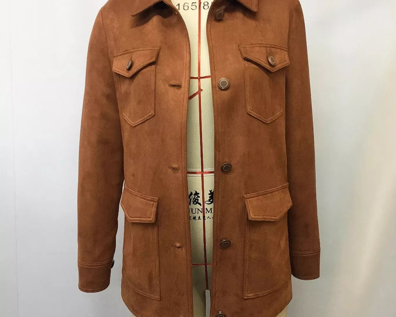 NEWYORKLISTED STYLE COLLECTION: Brown suede jacket on a mannequin against a white background
