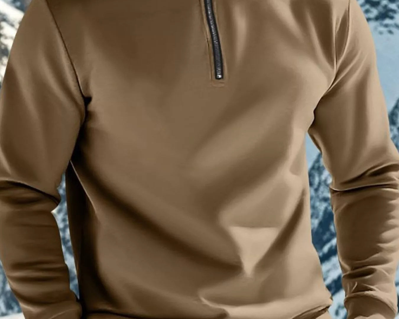 NEWYORKLISTED ATLAS MEN'S COLLECTION: Person wearing a beige pullover with a mountainous background