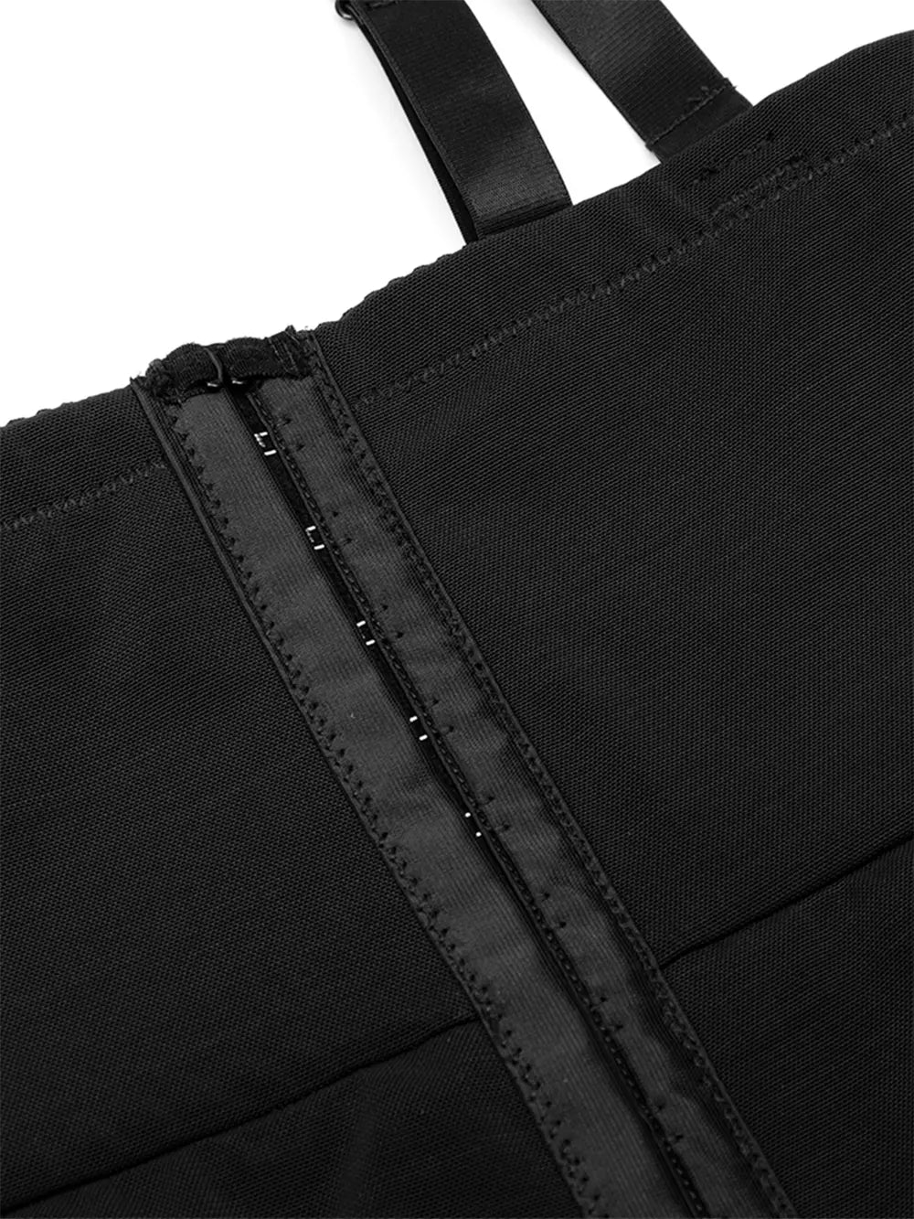 NEWYORKLISTED Intimate Apparel: Close-up of a black bag with straps on a white background