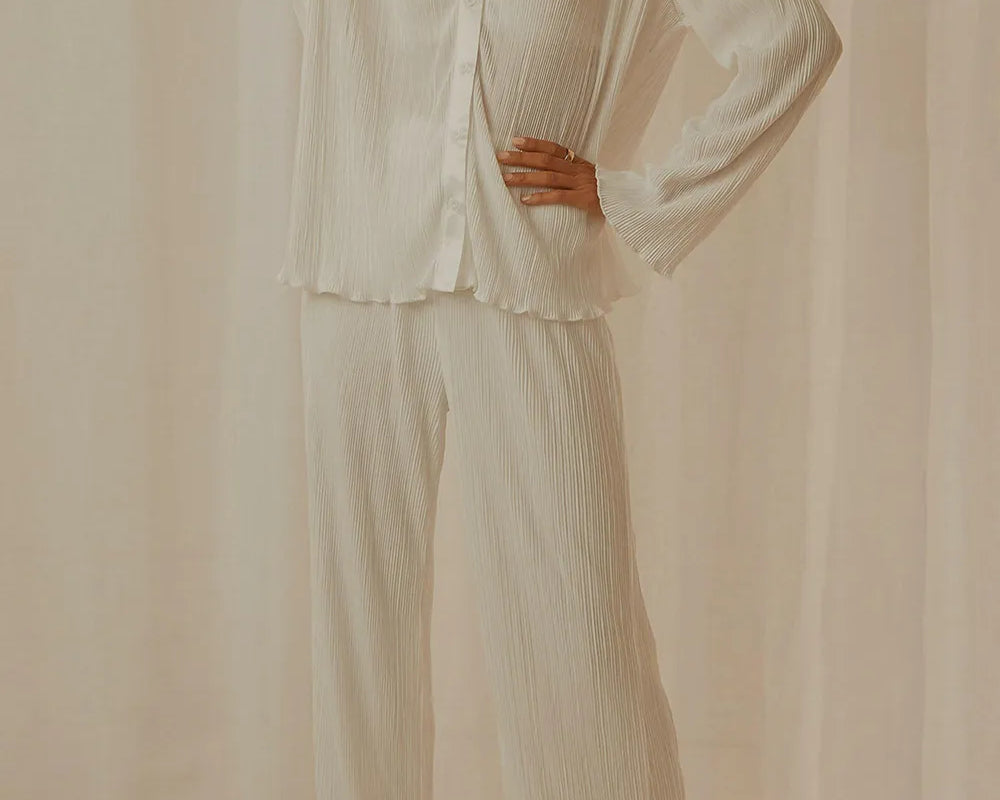 NEWYORKLISTED Intimate Apparel Collection: Person wearing a white textured shirt and pants against a beige background