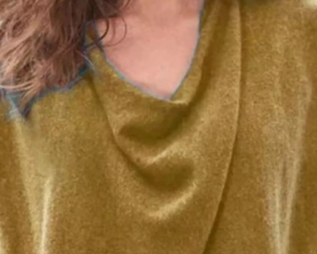 NEWYORKLISTED STYLE COLLECTION: Close-up of a mustard yellow sweater with a textured pattern