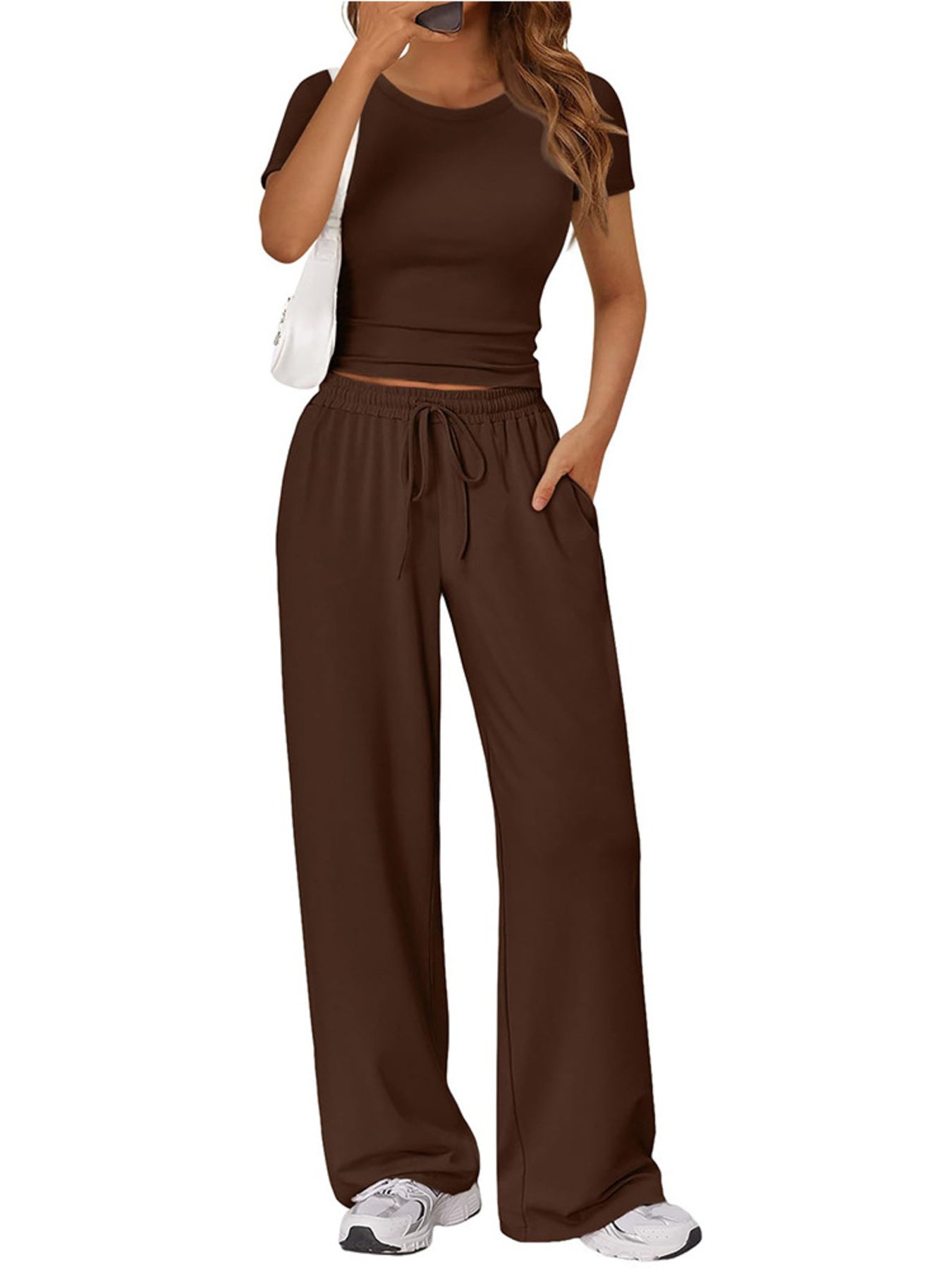NEWYORKLISTED COMFORT COLLECTION: Woman wearing a brown outfit with wide-leg pants on a white background