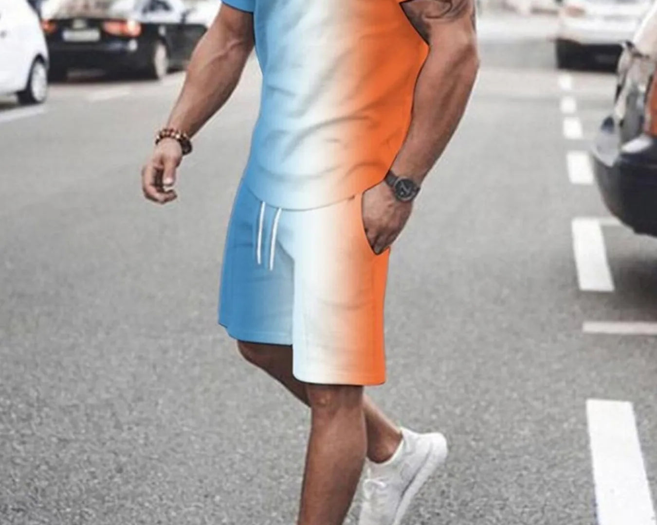 NEWYORKLISTED ATLAS MEN's COLLECTION: Person wearing a gradient t-shirt and shorts walking on a street.