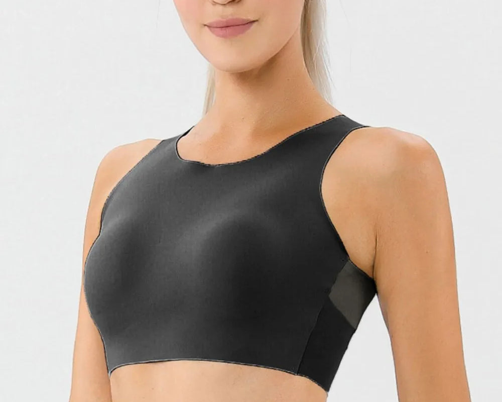 NEWYORKLISTED ACTIVEWEAR COLLECTION: Woman wearing a black sports bra against a light gray background