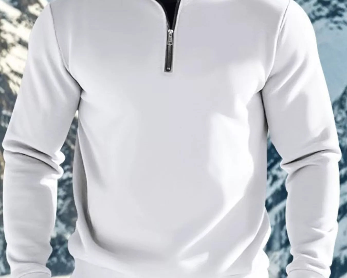 NEWYORKLISTED ATLAS MEN'S COLLECTION: Person wearing a white quarter-zip sweatshirt with a mountainous background
