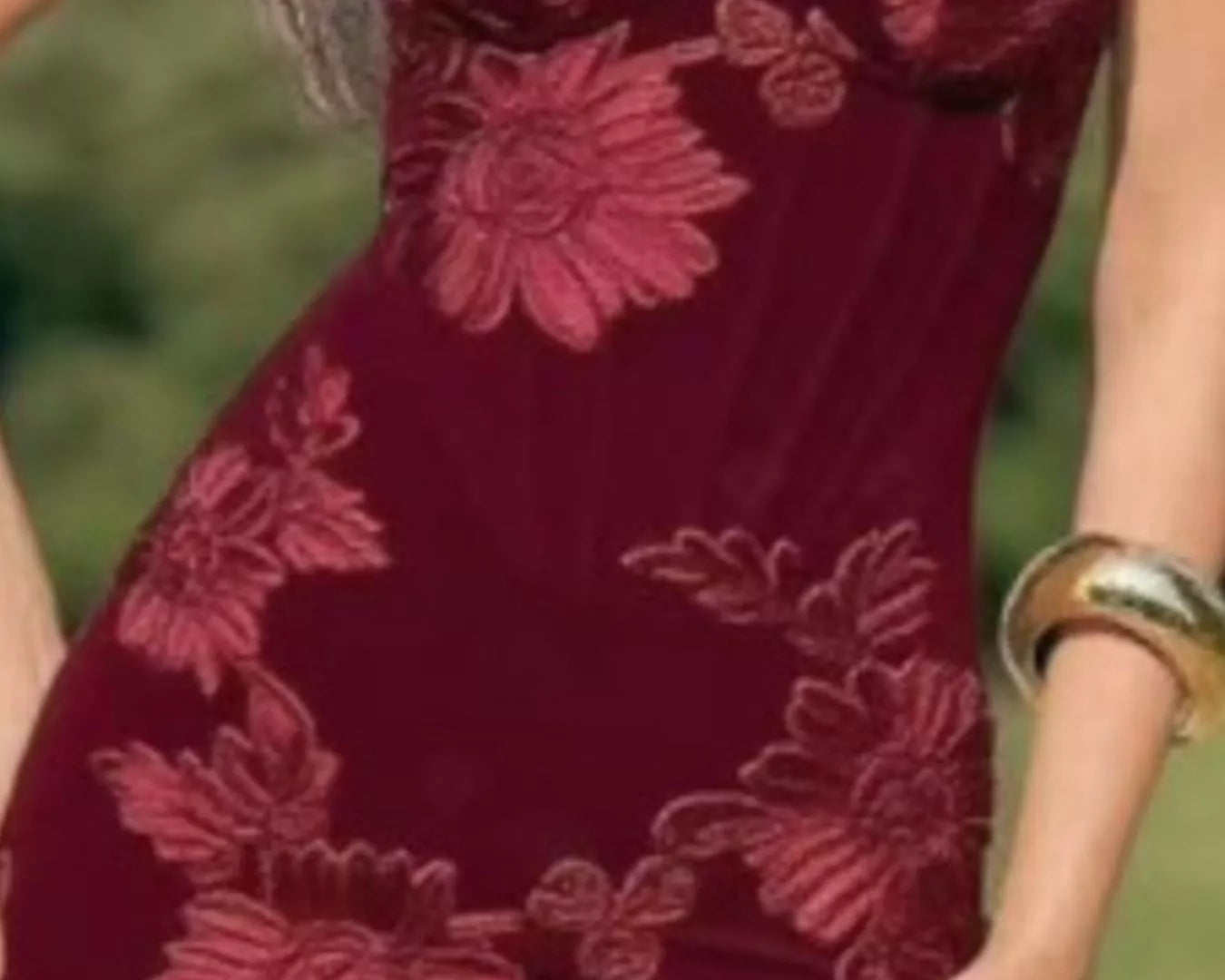 NEWYORKLISTED STYLE COLLECTION: Red strapless dress with floral patterns worn by a person outdoors.