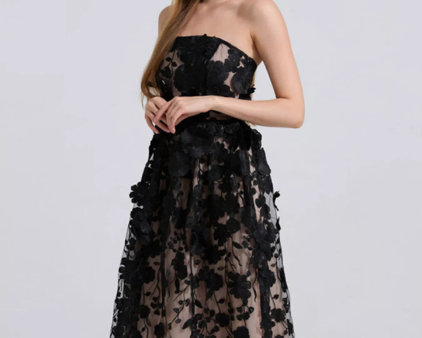 NEWYORKLISTED STYLE COLLECTION: Black lace strapless dress worn by a model on a white background