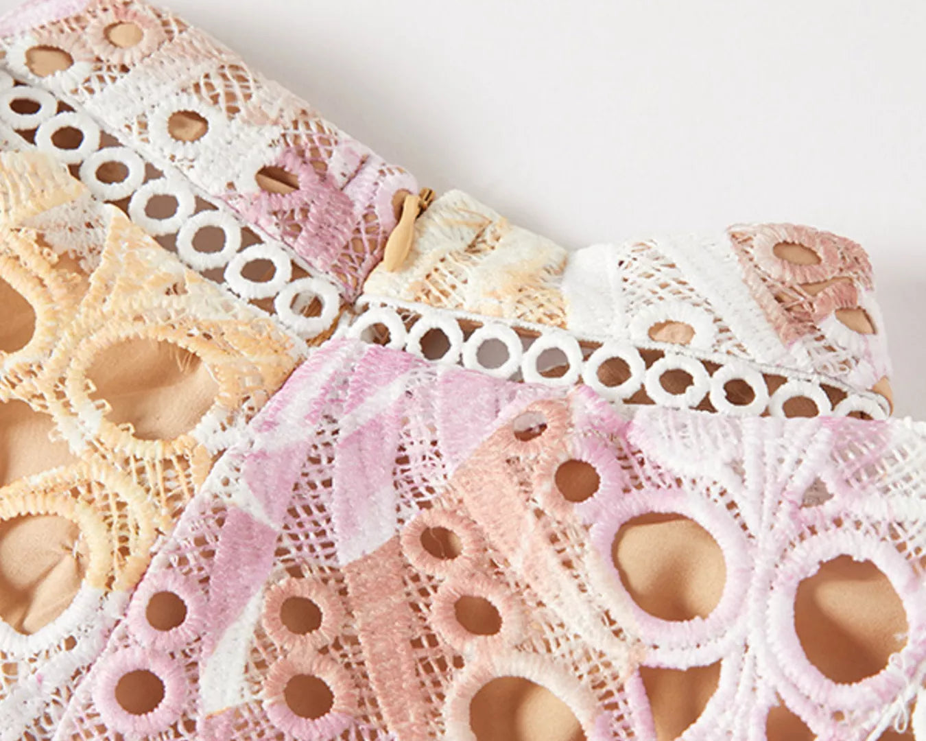 NEWYORKLISTED STYLE COLLECTION: Close-up of lace fabric with a white background