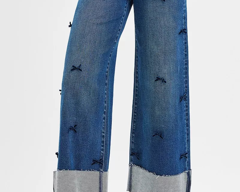 NEWYORKLISTED STYLE COLLECTION: Blue wide-leg jeans with decorative elements on a white background