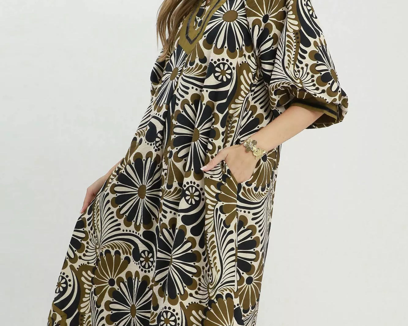 NEWYORKLISTED STYLE COLLECTION: Woman wearing a patterned dress with a white background