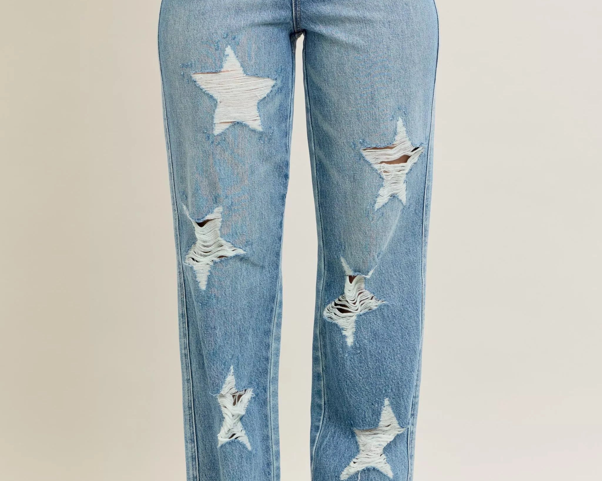 NEWYORKLISTED STYLE COLLECTION: Blue jeans with star patterns on a plain background