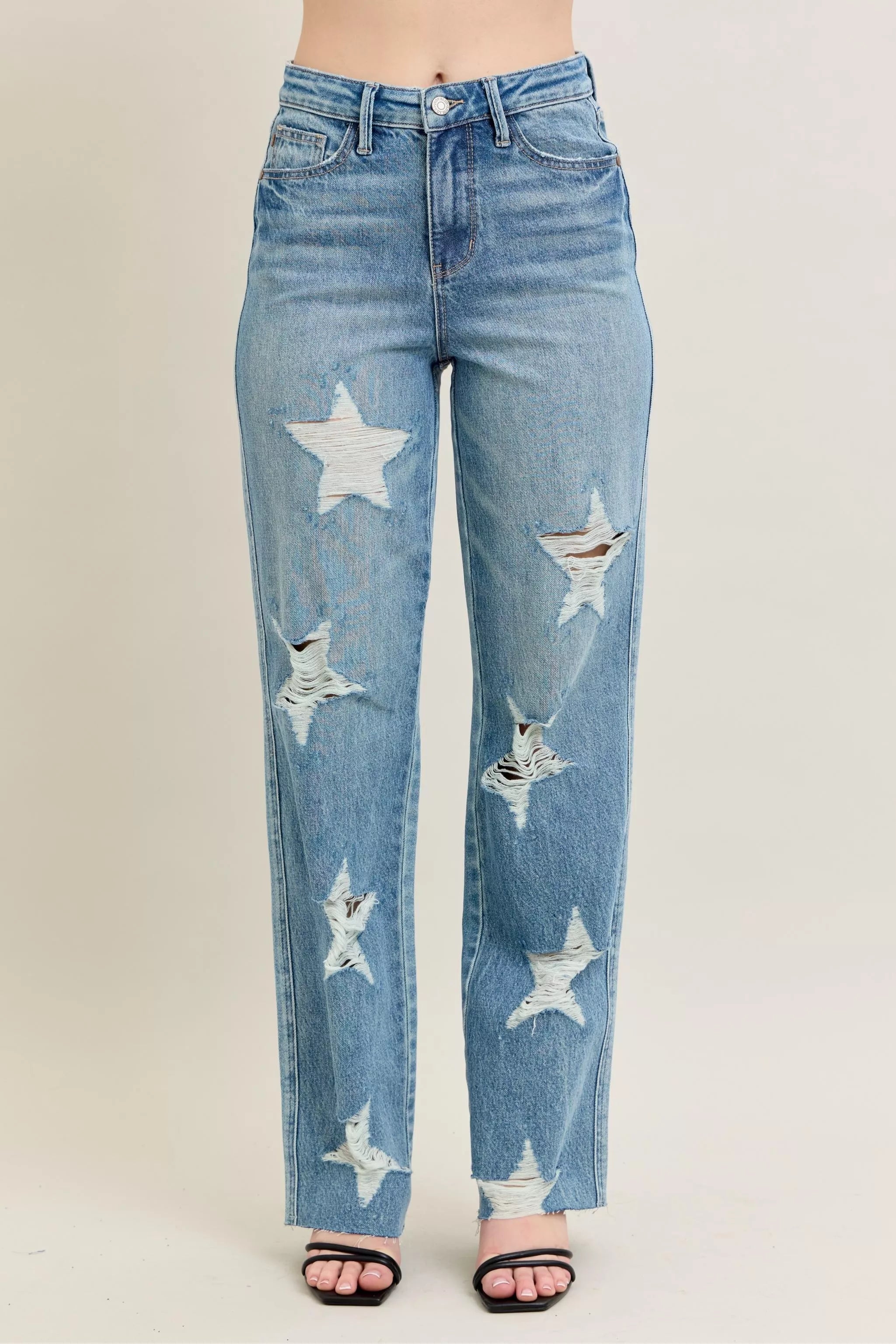 NEWYORKLISTED STYLE COLLECTION: Blue jeans with star patterns on a plain background