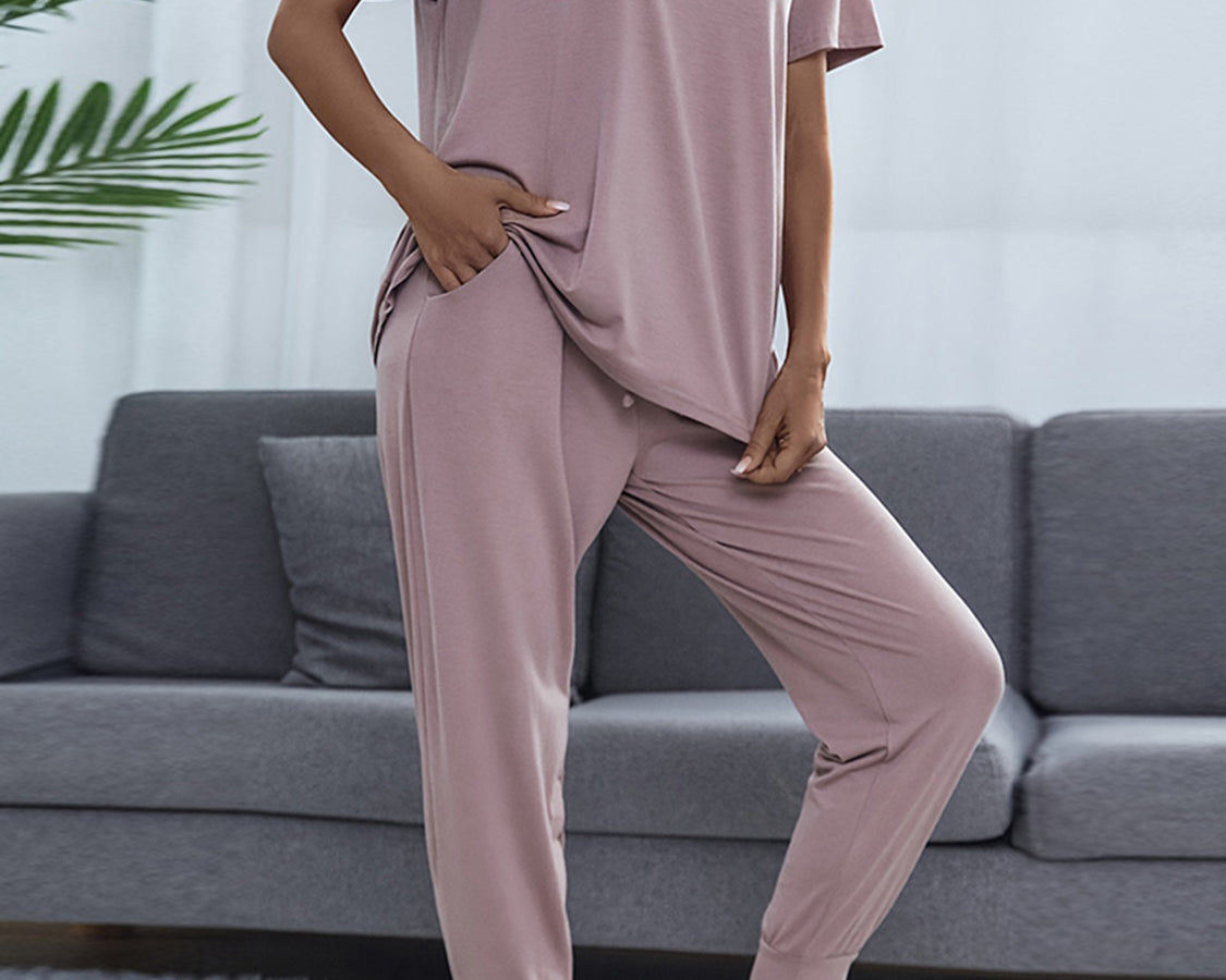 NEWYORKLISTED Intimate Apparel: Person wearing a mauve pajama set in a living room setting.