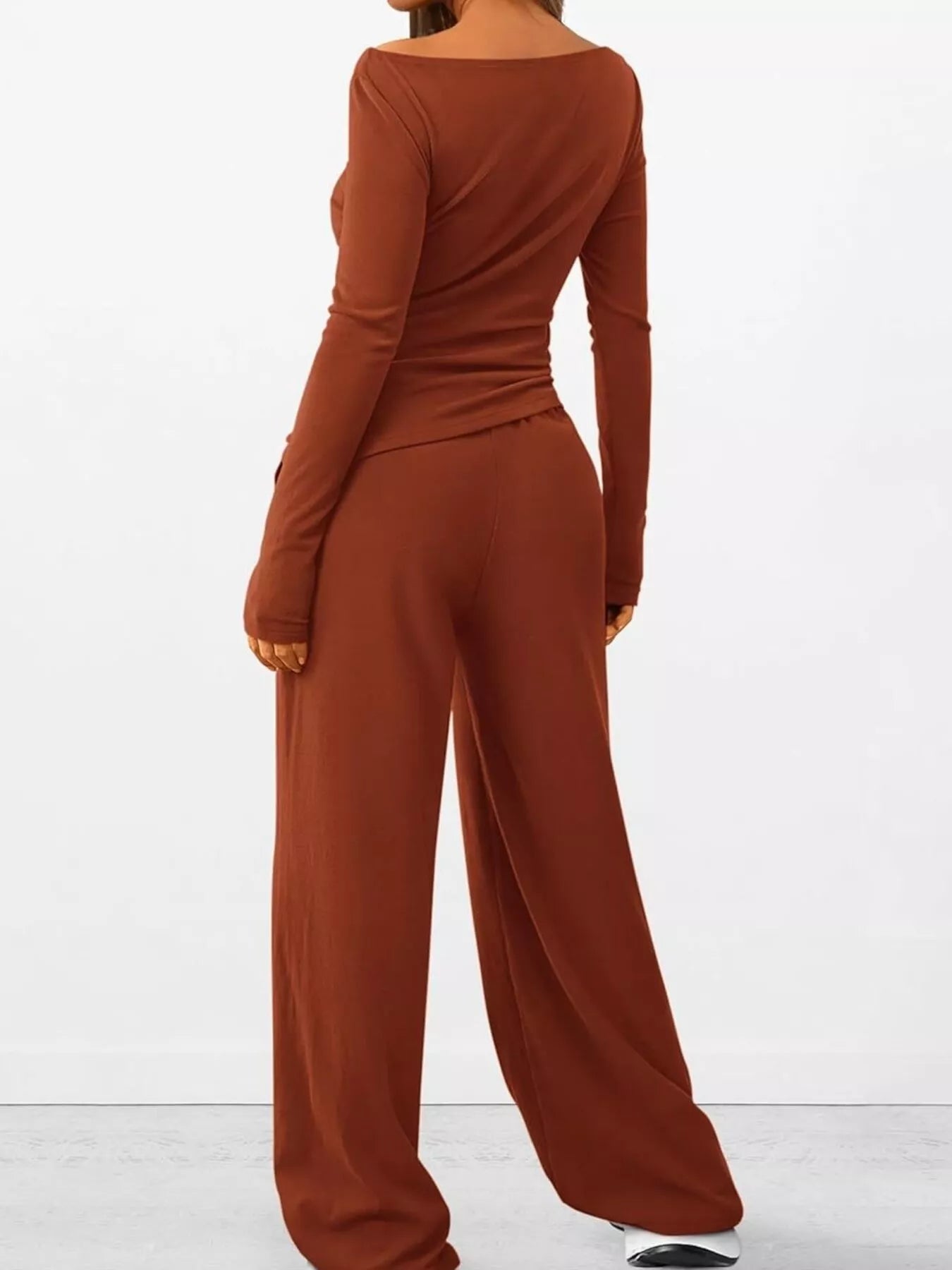 Brown long-sleeve top and wide-leg pants set on a white background
