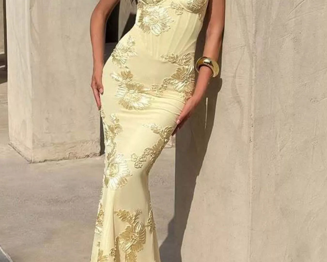 Woman wearing elegant embroidered lace sweetheart neckline spaghetti strap maxi dress with side split from NEWYORKLISTED STYLE COLLECTION