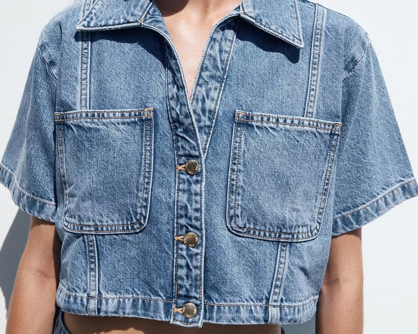 NEWYORKLISTED STYLE COLLECTION: Person wearing a blue denim jacket and shorts against a white background