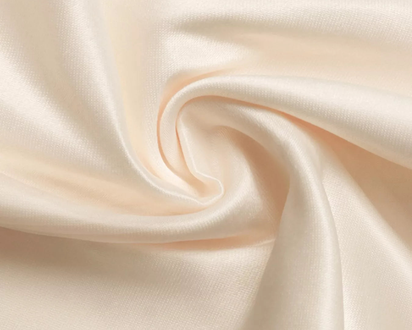 Close-up of smooth, beige fabric with folds